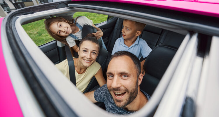 family in car laughing