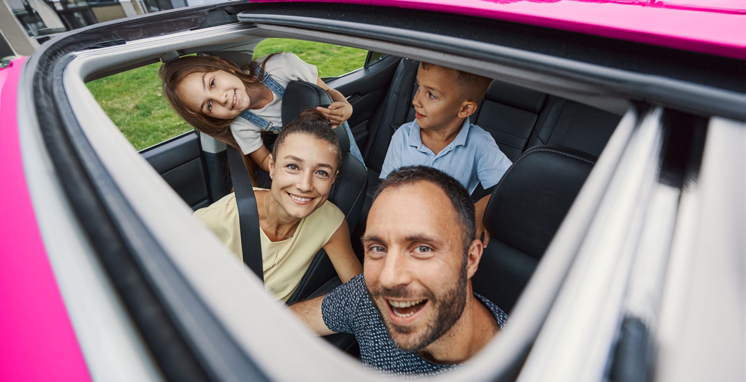 family in car laughing